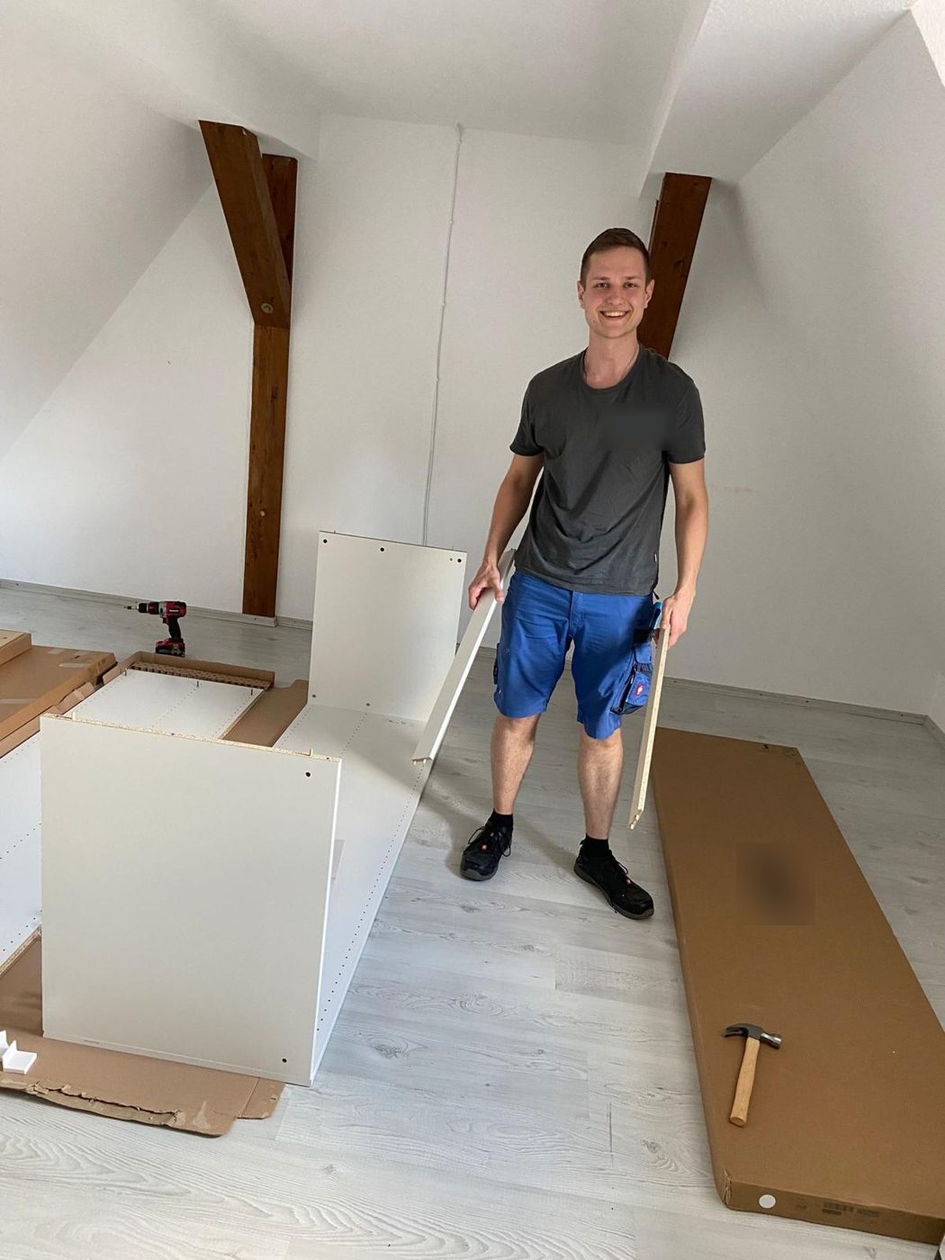 Jan-Henrik Müller beim Möbelaufbau in einem Dachgeschoss